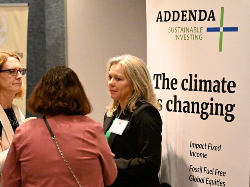 Photo taken during the Together25Ensemble conference featuring two women in conversation